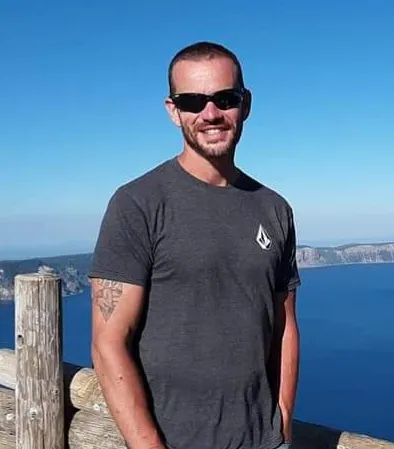 Colin McVay, owner of McVay Construction LLC, outdoors on a sunny day