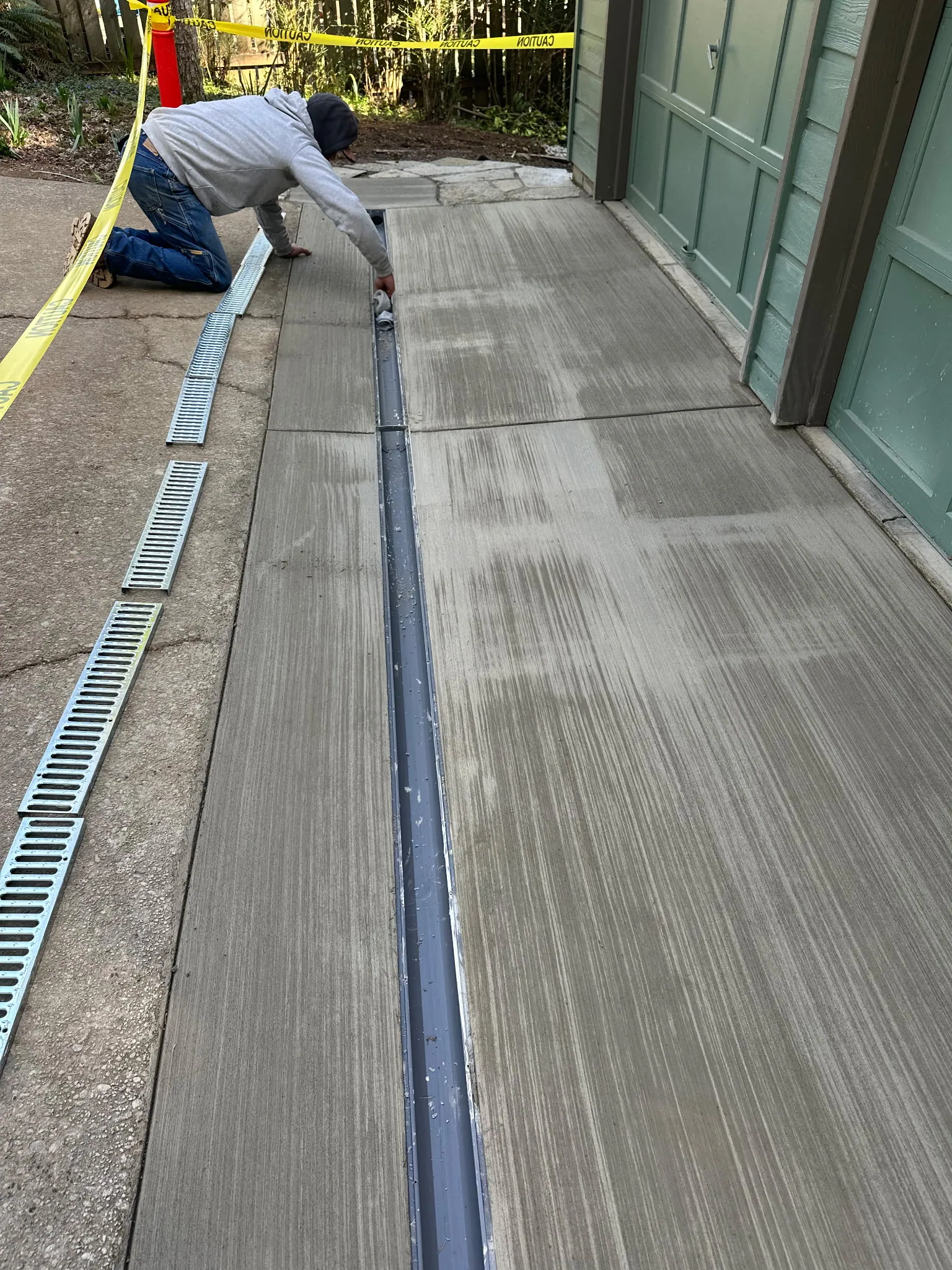 Setting a slotted trench drain grate in new concrete in front of a garage